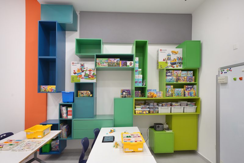 Green and blue shelving units full of LEGO Education sets